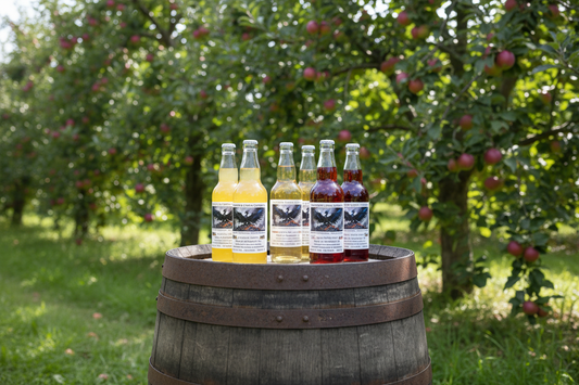 Wrexham Cider bottles on barrel in apple orchard